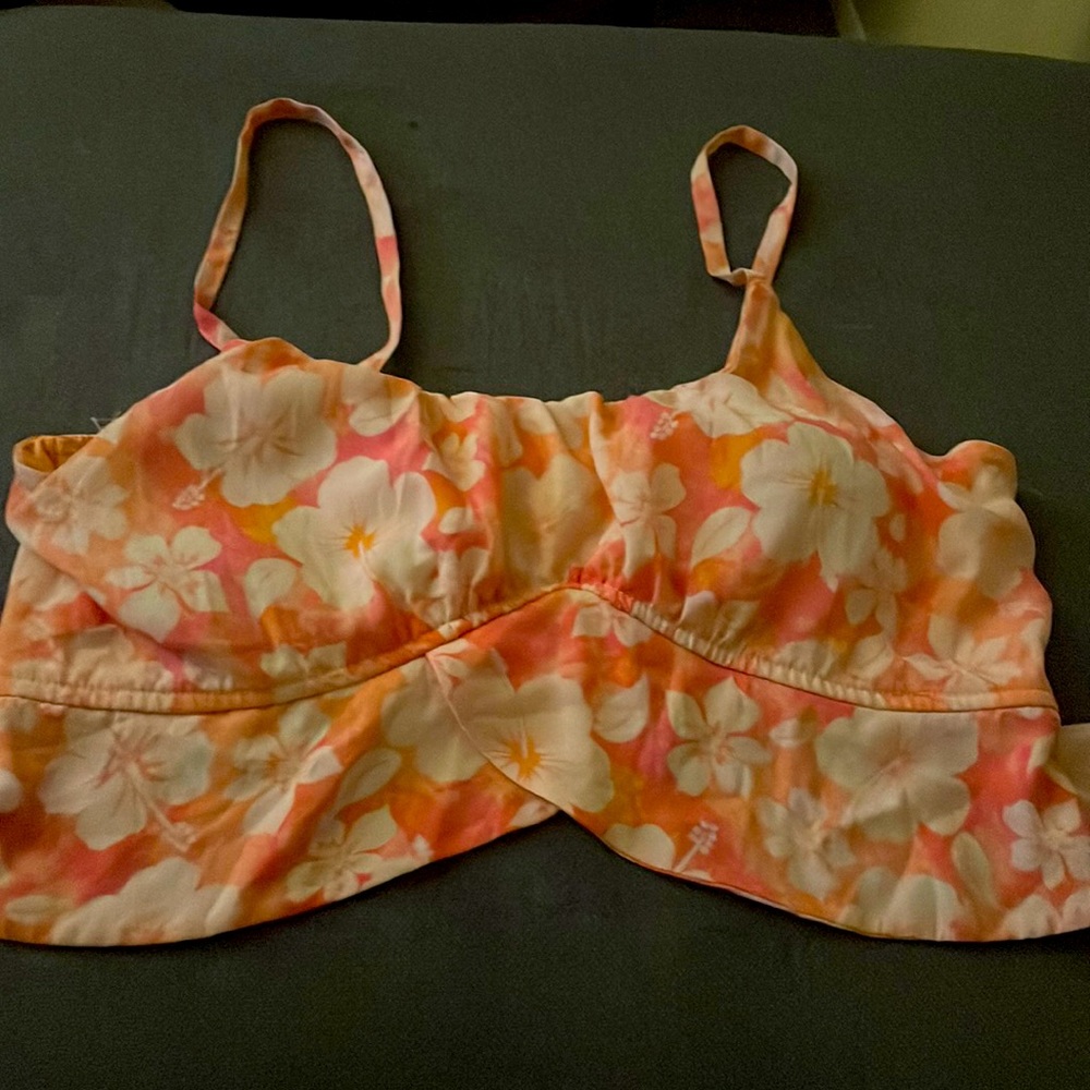 A  bright orange and white crop top size is large
